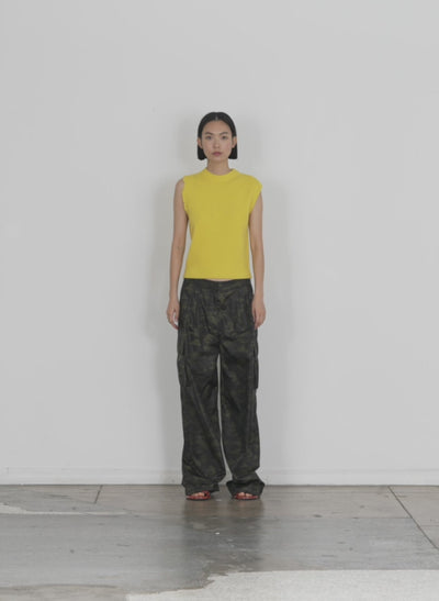 Model wearing the anna merino wool minime distressed vest bright yellow walking forward and turning around