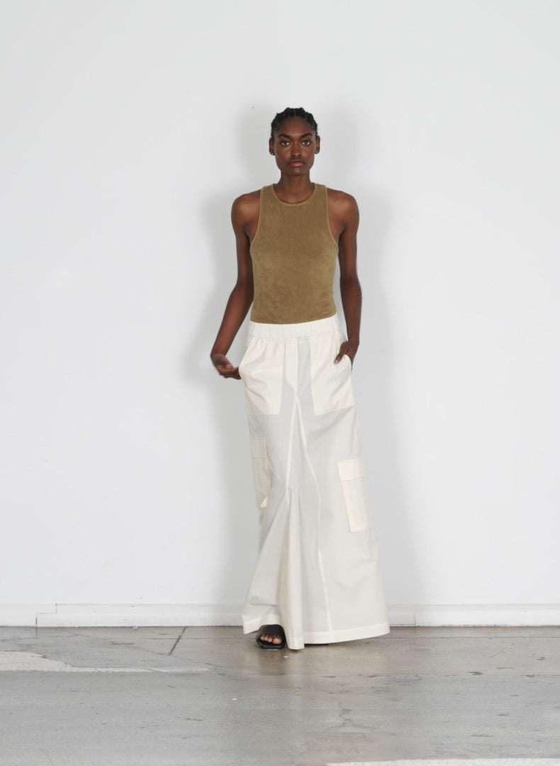Model wearing the vintage cotton pull on cargo godet skirt cream walking forward and turning around