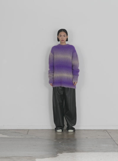 Model wearing the ombre superfine alpaca funnel neck pullover purple multi walking forward and turning around