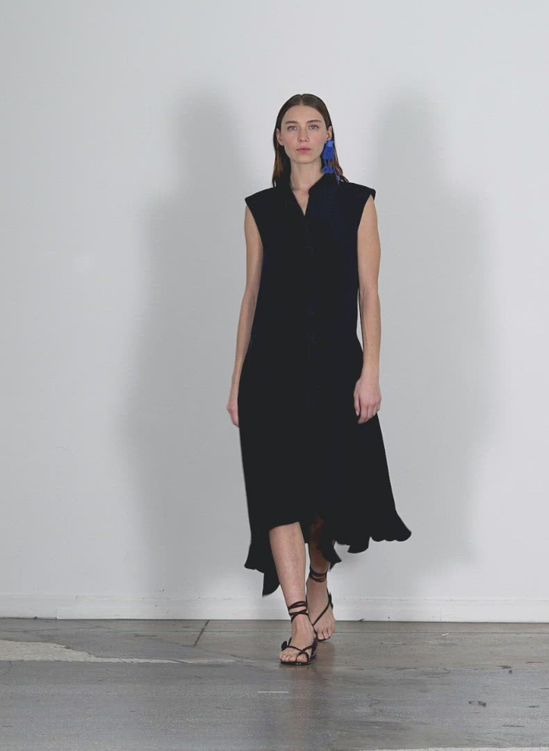 Model wearing the eco silk detached ruffle shirtdress dark navy walking forward and turning around