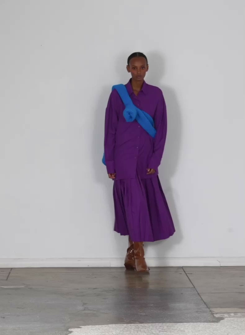 Model wearing the italian sporty nylon shirt w cocoon back purple walking forward and turning around