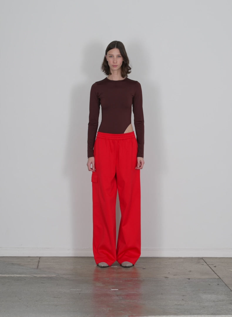 Model wearing the active knit wide leg pullon pant red walking forward and turning around