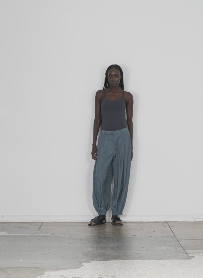 Model wearing the ribbed t racerback bodysuit dark slate walking forward and turning around