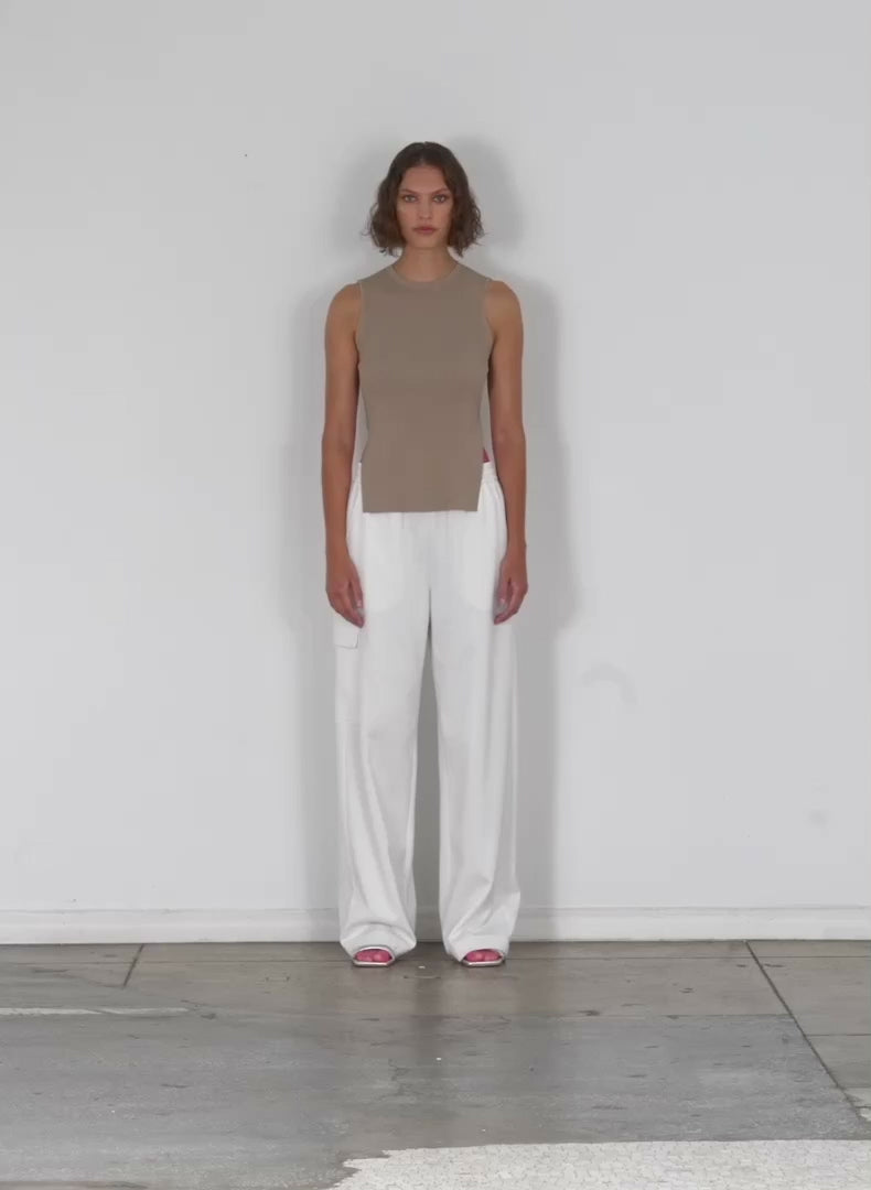 Model wearing the active knit wide leg pullon pant white walking forward and turning around